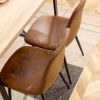 A set of 4 modern medieval style restaurant cushioned side chairs, equipped with soft cushions and black metal legs, suitable for kitchens, lounges, a